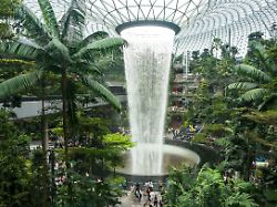 people visit the rain vortex indoor waterfall feature at jewel changi airport mall in singapore on july 11 2025
