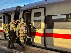 several german bundeswehr soldiers wear camouflage uniforms and large backpacks as they board an ice train car on a platform in munich bavaria germany on december 12 2025