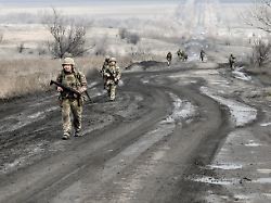 soldiers from the 141st mechanised brigade of the ukrainian land forces armed with rifles walk along a road on the front line march 19 2026