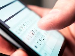 text message with smartphone man texting sms with phone catfish or mobile scam digital instant messaging chat macro close up of keyboard