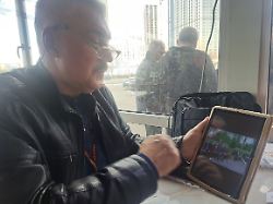 tschernobyl liquidator mychajlo bukow zeigt ein foto ehemaliger arbeitskollegen in der radioaktiv belasteten sperrzone um das akw tschernobyl der grossteil sei bereits gestorben