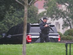 a u s secret service agent walks holding his weapon after alleged gunshots were heard nearby at the white house in washington d c u s may 23 2026 1