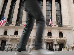 a person walks past the new york stock exchange in the financial district in manhattan new york city