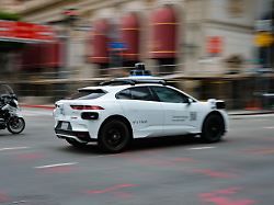a police officer riding a motorcycle follows a waymo driverless car as it drives through downtown los angeles california u s may 1 2026