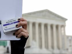 file an abortion rights activist holds a box of mifepristone pills as demonstrators from both anti abortion and abortion rights groups rally outside the supreme court in washington tuesday march 26 2024
