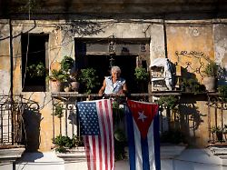 file javier yanez stands on his balcony where he hung a u s and cuban flag in old havana cuba friday dec 19 2014
