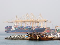 khor fakkan uae large cargo ships docked to load and unload goods at khor fakkport copyright xmoodboardx panthermedia75378306