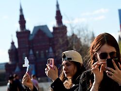 moscow russia aei may 3 a woman uses her mobile phone as she walks near the historic red square in the capital moscow russia on may 3 2026