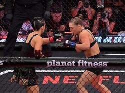 may 16 2026 los angeles california usa ronda rousey blue gloves fights gina carano red gloves in a women s featherweight bout at intuit dome 7