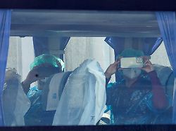 passengers from the cruise ship mv hondius affected by a hantavirus outbreak record using their mobile phones aboard a bus at the port of granadilla de abona in tenerife spain may 10 2026