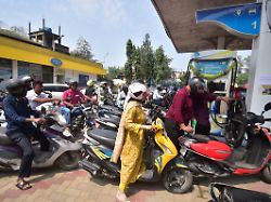 people queue to fill petrol in their two wheelers at a fuel station in nagaon district assam india on march 26 2026