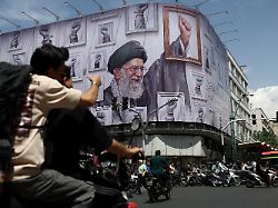 people ride motorcycles near a billboard featuring an image of the late supreme leader of iran ayatollah ali khamenei in tehran iran may 6 2026