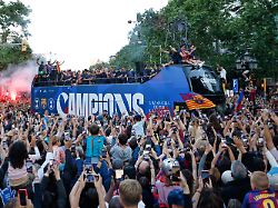 surrounded by supporters fc barcelona players celebrate atop a bus after winning the spanish la liga title in barcelona spain monday may 11 2026