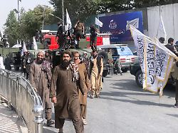 taliban security officers and supporters celebrate the fourth anniversary of the group s return to power in kabul on aug 15 2025