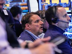 trader michael milano center works with colleagues on the floor of the new york stock exchange wednesday may 13 2026