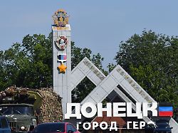 a military truck rides past a road sign reading donetsk in the city of donetsk russian controlled ukraine on july 17 2025 amid the ongoing russian ukrainian conflict