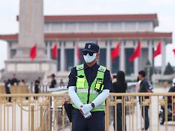 a police officer stands guard in tiananmen square with the chairman mao zedong memorial hall and the monument of the people s heroes in the background in beijing china june 4 2026