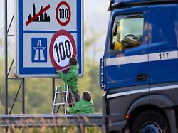 aktivisten von greenpeace ueberkleben an der autobahn 93 a93 ein hinweisschild mit den tempolimits auf deutschen strassen die angabe fuer richtgeschwindigkeit 130 auf autobahnen mit einem tempolimit