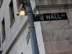 file photo the wall street sign hangs outside the new york stock exchange nyse building on tuesday following monday s broad sell off in new york city u s march 11 2025