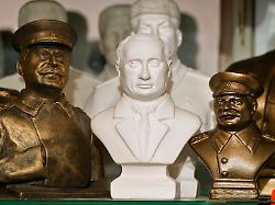 figurines depicting russian president vladimir putin centre and soviet dictator josef stalin are displayed for sale at a street souvenir shop in st petersburg russia wednesday july 10 2024