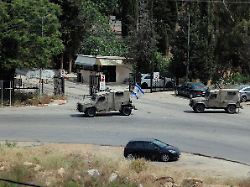 israeli troops in armorede vehicles raid the outer courtyard of birzeit university in ramallah central west bank on may 15 2025