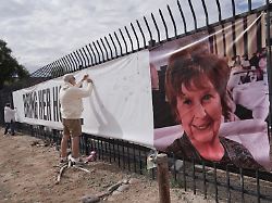 jeff robb a seattle resident wintering in tucson signs a banner supporting nancy guthrie in tucson ariz on friday feb 13 2026