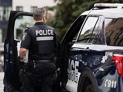 october 8 2024 montreal pq canada an spvm police officer gets out of his patrol car in montreal tuesday oct 8 2024