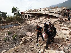 police carry a body from a building that collapsed after earthquakes struck la guaira venezuela thursday june 25 2026
