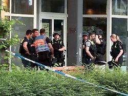 polizisten haben sich vor einem mehrfamilienhaus versammelt nachdem ein mann durch schuesse lebensgefaehrlich verletzt worden ist der mutmassliche taeter fluechtete wie die polizei mitteilte