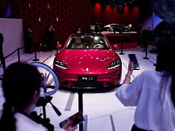 staff members conduct a live streaming session to promote saic z7 electric sedan at the beijing international automotive exhibition auto china in beijing china april 24 2026