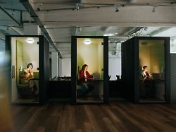 team working on laptops in modern soundproof office cubicles model released symbolfoto ytf04733