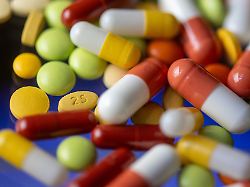 verschiedene tabletten kapseln und dragees liegen auf einem tisch
