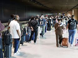 viele reisenden stehen im gang zur einreise in einer langen schlange an und muessen wartezeiten in kauf nehmen terminal 3 am fraport flughafen frankfurt hessen deutschland 01 06