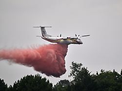 a de havilland canada dhc 8 400 dash 8 operated by the french civil defense agency drops fire retardant as wildfires rage near marcheprime outside bordeaux france monday july 27 2026