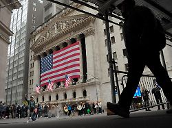 a person walks past the new york stock exchange in the financial district in manhattan new york city