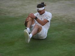alexander zverev of germany reacts after falling over during a point against jannik sinner of italy in the men s singles final at wimbledon tennis championships in london sunday july 12 2026