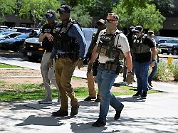 file photo masked law enforcement officers including hsi and ice agents walk into an immigration court in phoenix arizona u s may 21 2025 1