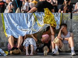 fans der band kraftklub schuetzen sich vor beginn des konzerts im rahmen der sterben in karl marx stadt open airs 2026 im rudolf harbig stadion unter rettungsfolien vor der sonne