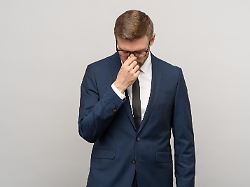 heartbroken exhausted man businessman in suit office worker worried about bankruptcy job loss on grey background upset guy feeling bad headache migraine after busy day burnout overwork concept