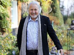 konrad beikircher kabarettist musiker und autor steht in seinem garten