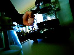 man holds jug of filter coffee maker