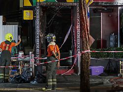 members of emergency services work outside a pub where a deadly fire broke out in bangkok thailand july 13 2026 1