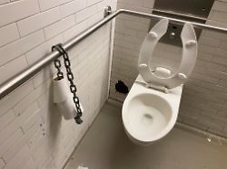 new york ny usa may 28 2021 toilet paper chained to steel bar in public restroom to prevent theft of the entire roll of toilet paper