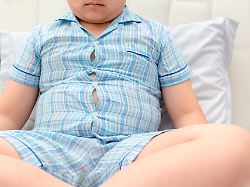 obese fat boy overweight sit on bed