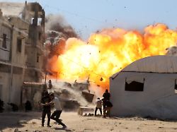 palestinians attempt to take cover from a massive explosion following an israeli airstrike targeting a blacksmith workshop in the al sabra neighborhood of gaza city on july 12 2026
