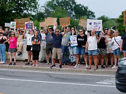 people hold signs as they protest against u s immigration and customs enforcement ice at mechanics park after a shooting involving ice in biddeford maine u s july 13 2026