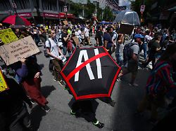 people participate in a march to protest the opening of ai data centers in vancouver british columbia saturday june 27 2026