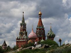 people walk in zaryadye park near st basil s cathedral and the kremlin s spasskaya tower in central moscow russia july 6 2026