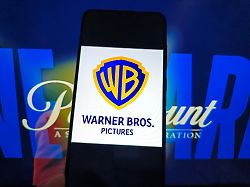 suqian china april 24 2026 a netizen is using a computer and smartphone to view warner bros logo and paramount webpage in suqian city jiangsu province china on april 24 2026