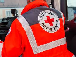 sanitaeter vom drk deutsches rotes kreuz steigt in ein einsatzfahrzeug auf dem fruehlingsfest in schwabmuenchen